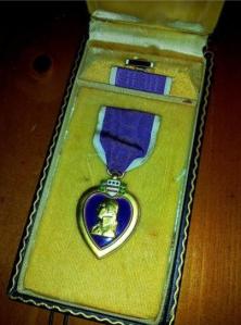 This is a World War II Purple Heart Medal set complete with the ribbon and lapel device in the correct presentation case.
