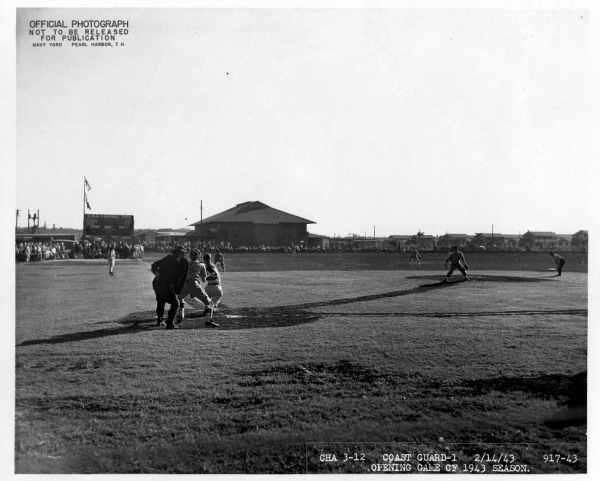 The opening game of the 1943 baseball season at Furlong Field. This diamond would see dozens of baseballs brightest and best don their spikes and military-team flannels to entertain the troops stationed in Hawaii during WWII.