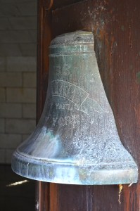 Bell of the USS Maine, broken in half by the 1898 explosion, attached to the door of the memorial at Arlington National Cemetery.