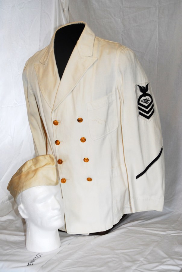 Pictured here with an early WWII chief radioman's eight-button, dress white uniform jacket, the (yellowing and aged) white garrison cover is a bit more distinguishable from a khaki variant.