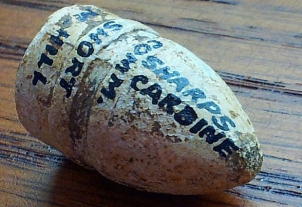 Showing the beautiful labeling on the .52 caliber Sharps Carbine round acquired for my shadow box display.