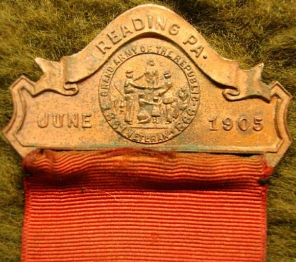 The national encampment medal's brooch reflects the date and location of the 1905 Reading, PA gathering with the GAR seal prominently displayed in the center (source: eBay image).
