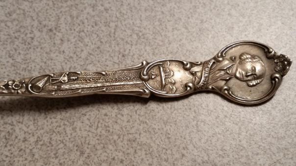 The USS Tacoma spoon is far more ornately decorated with fine details - embelishments of various aspects of Washington State and the city of Tacoma.