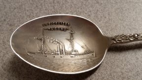 The inside of the bowl has a very detailed depiction of the cruiser. The reverse of the spoon is engraved with "1907, Helen."