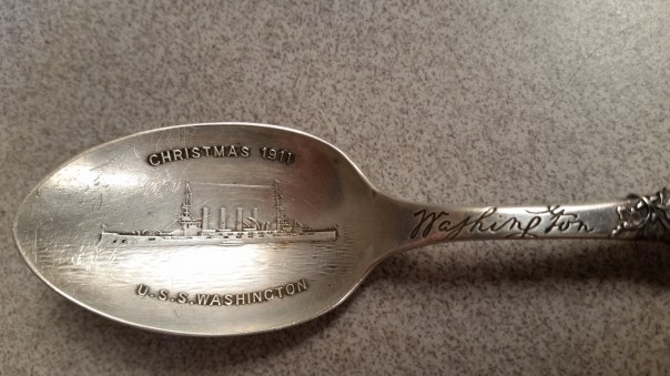 The armored cruiser, USS Washington is beautifully captured in relief in the spoon's bowl along with the details commemorating Christmas of 1911.