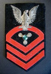 This early Machinist's Mate crow (right-arm rate) is embellished with a stone in the center of the propeller specialty mark (eBay photo).