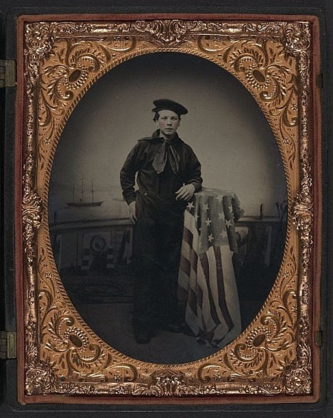 Leaning against a flag-draped table, this sailor’s uniform trouser-buttons are clearly visible and show the 7-button configuration (source: Library of Congress).