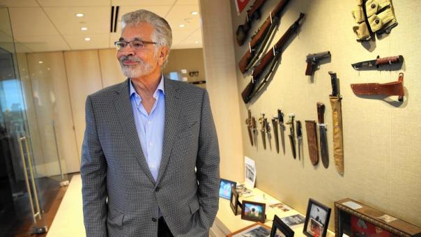 Dick Portillo, shown with military memorabilia in his Oak Brook office Sept, 8, 2016, is on a quest to determine whether a gold tooth discovered on a Pacific island is that of Japanese Cmdr. Isoroku Yamamoto, who planned the Pearl Harbor attack and who was shot down in 1943. (Terrence Antonio James / Chicago Tribune)
