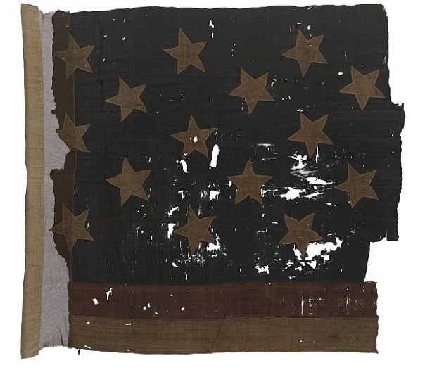 Now on display at the National Maritime Museum in Greenwich, England, the blood-stained and bullet hole riddled ensign from the defeated USS Chesapeake (source: National Maritime Museum).