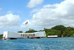 The memorial structure straddles the stricken ship’s hull as she rests in the mud and silt of Pearl Harbor.