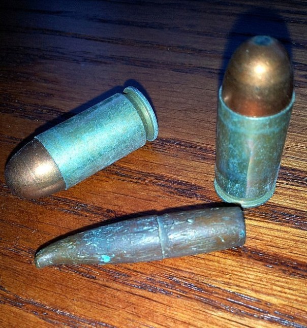 The crimp ring around the middle of the bullet’s length shows where the top of the bullet casing was pressed against the projectile. When compared to these WWII .45cal rounds, it becomes apparent that the bullet is in the 7mm bore size-range.