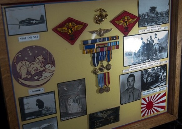 This display features WWII USMC ace, Major Bruce Porter’s decoration and medals with his naval aviator “wings of gold.”